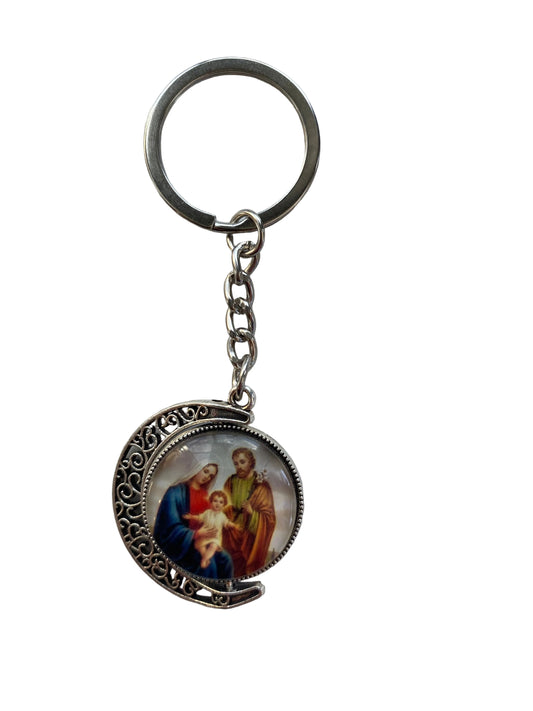 Keychain with religious-themed design on a light gray background